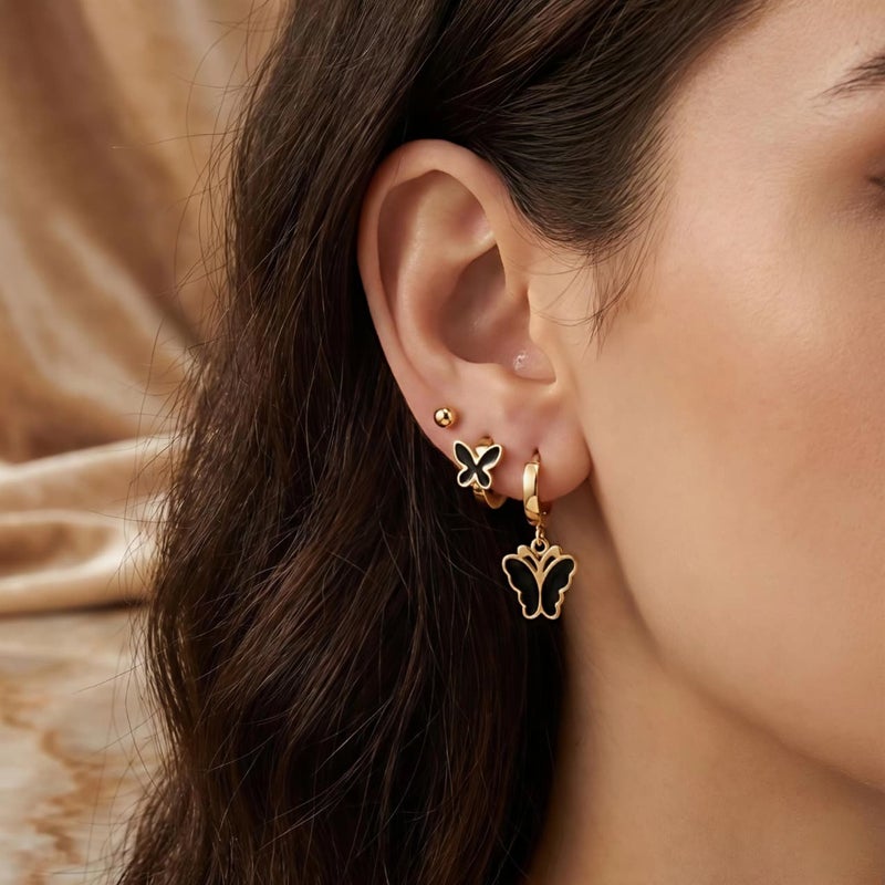 A set of 3 pairs of distinctive gold earrings: gold ball screw, black butterfly-adorned hoops, and a larger, luxurious butterfly pendant. Made of rust-resistant stainless steel for a brilliant shine. - Image 3